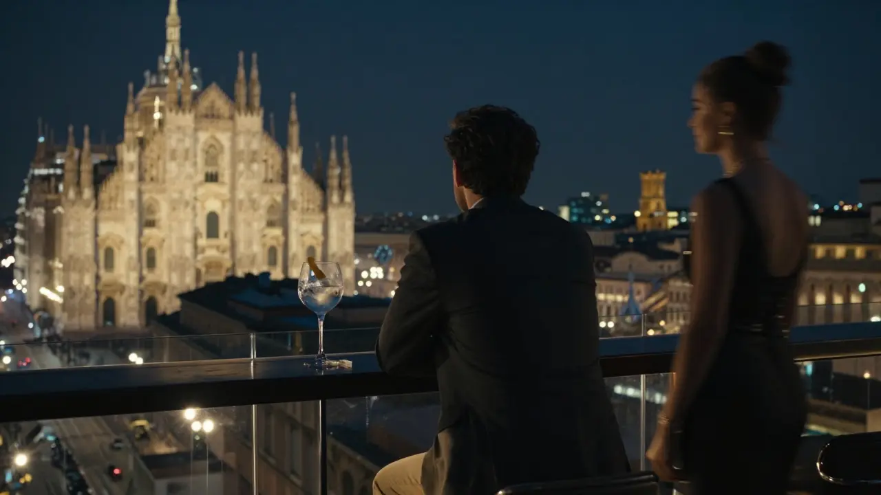 A man stands alone at a luxury hotel rooftop bar, gazing over Milan’s illuminated skyline at night.